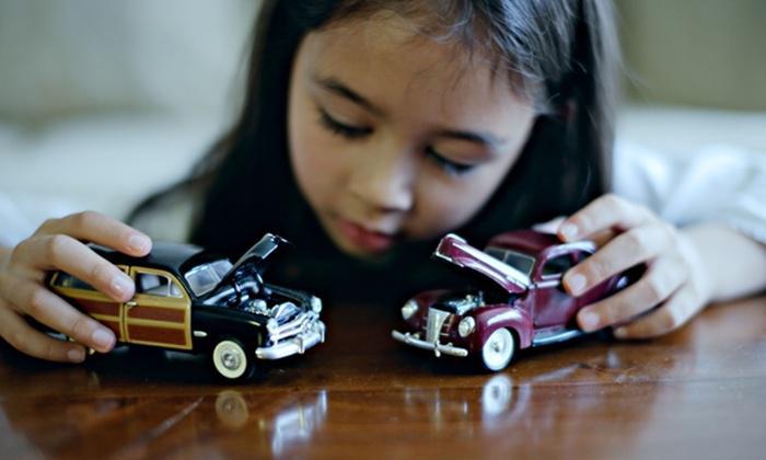 Girl plays with toy cars